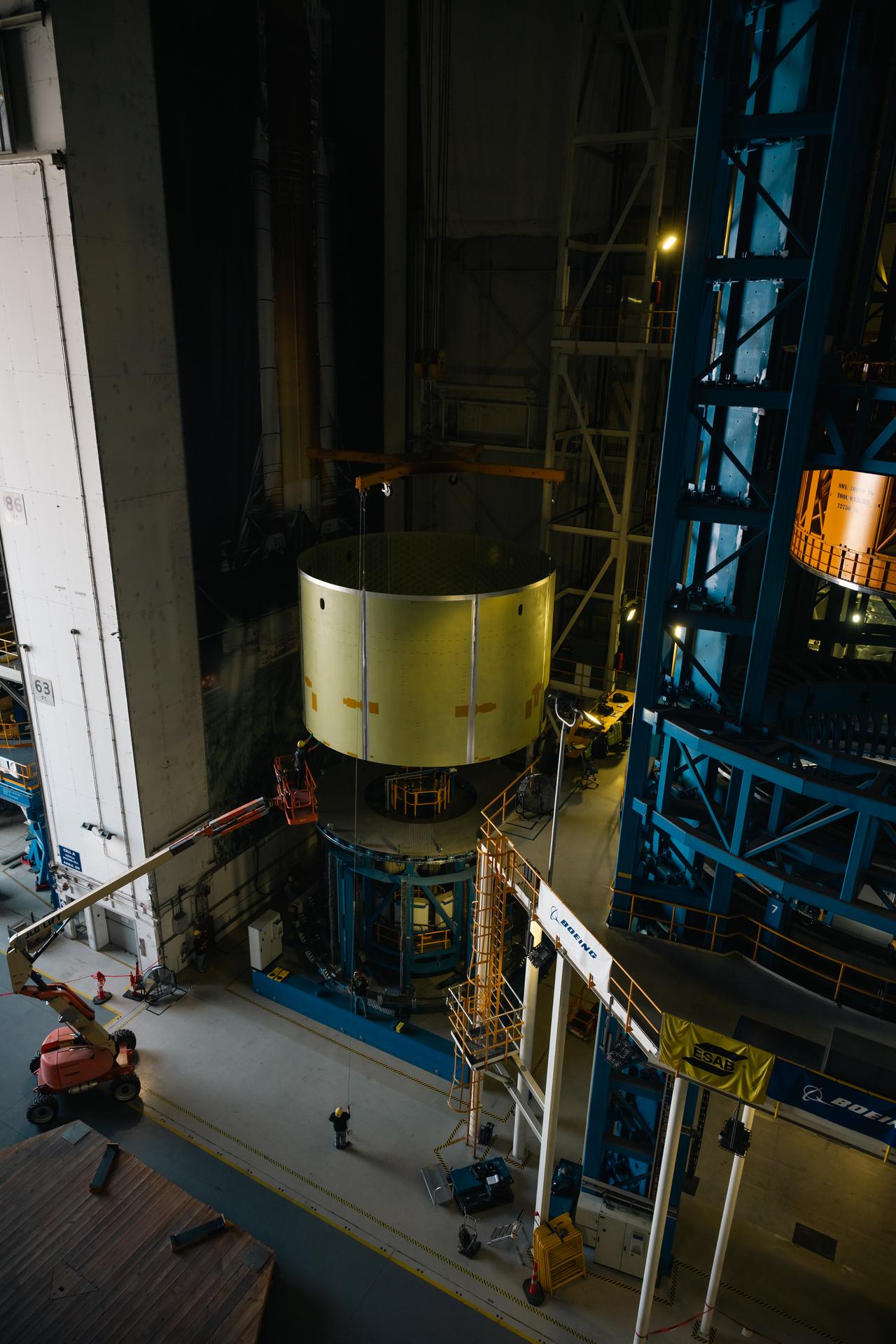 Teams at Michoud Assembly Facility in New Orleans load the engine section barrel into the vertical assembly center on Aug. 5, 2026. The engine section will be used on the SLS (Space Launch System) rocket’s core stage for the agency’s Artemis V mission. On the vertical assembly center tooling, teams will mate the flight hardware to a ring, which will serve as an attachment point for the liquid hydrogen tank later in the production process. The engine section is one of five major elements that make up the 212-foot-tall SLS rocket stage; and houses various avionic systems, the engine thrust structure, and four RS-25 engines. The core stage produces more than two million pounds of thrust to help launch NASA’s Orion spacecraft, astronauts, and supplies beyond Earth’s orbit and to the lunar surface for Artemis.